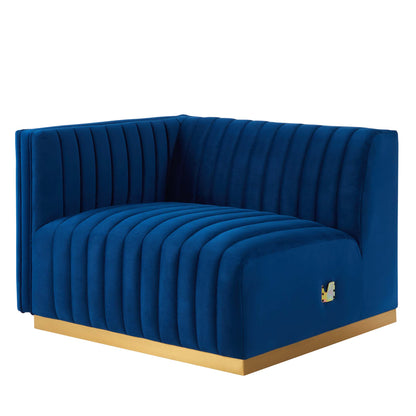 Navy blue velvet curved left-arm chair with vertical channel tufting on a gold base.