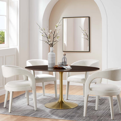 Round dark wood dining table with gold pedestal base, four white curved-arm chairs in a bright arched dining nook.