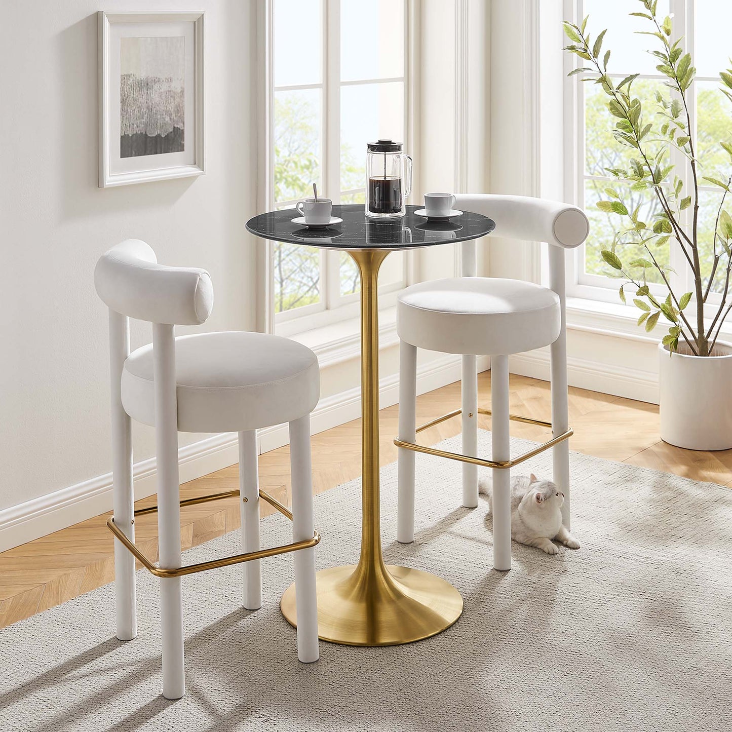 Modern bar table: black round faux-marble top on a gold pedestal in a bright sunlit room.