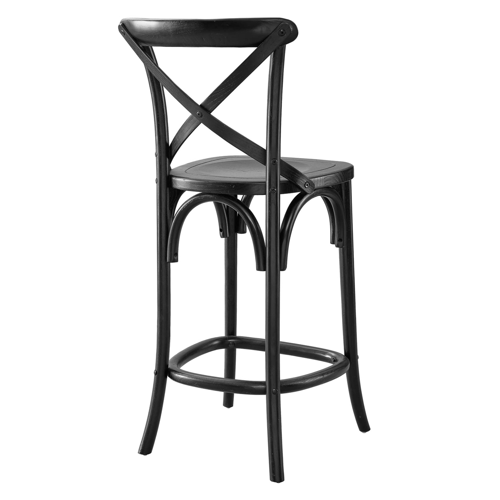 Black metal bar stool with X-back, round seat, and circular footrest; tall cafe-style chair.