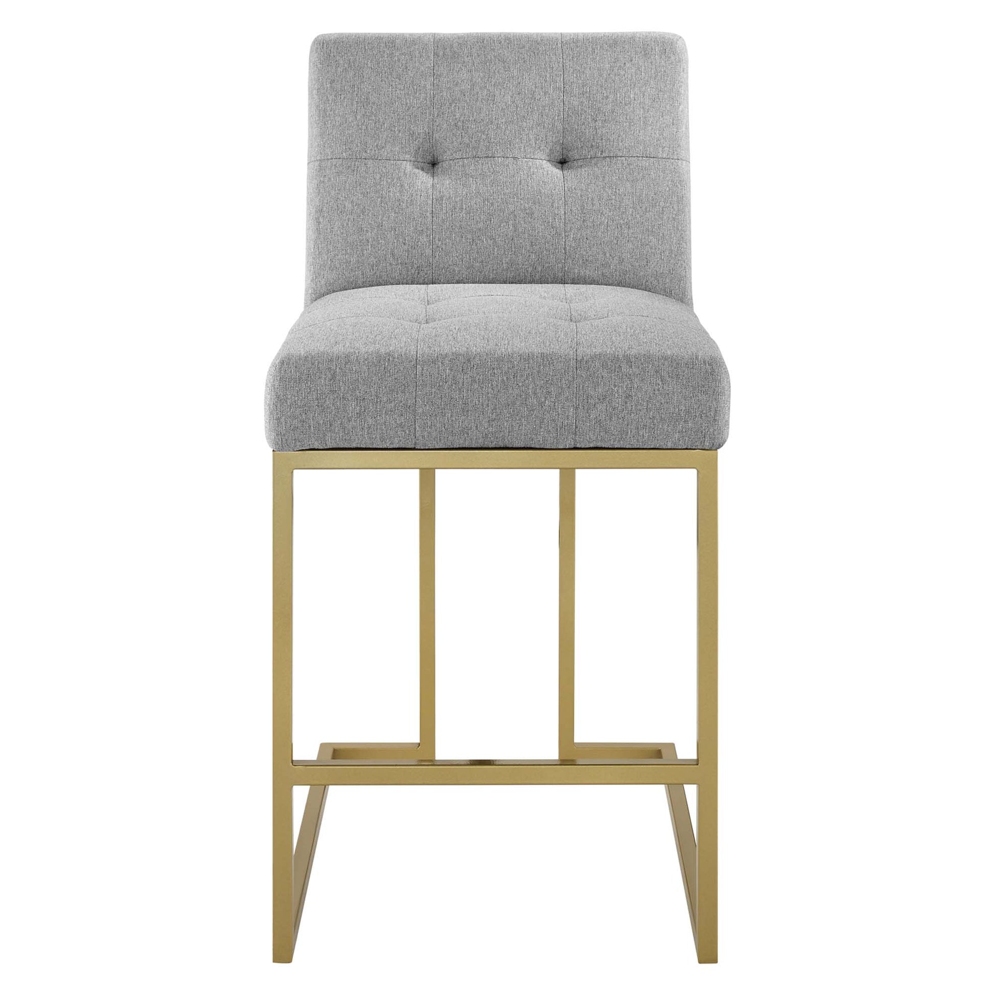 Gray tufted fabric counter stool with a gold metal frame, backrest and footrest, modern counter seating.