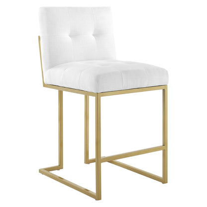 White tufted upholstered fabric counter stools with backrests, gold metal frames, and footrests; set of 2.