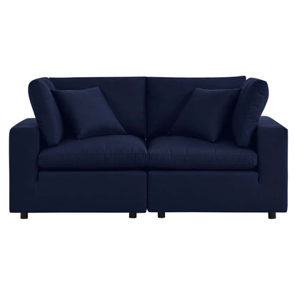 Navy blue fabric 2-seat sofa with square arms, two back cushions and two bolster pillows.