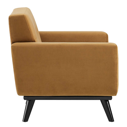 Cognac velvet armchair with square arms, padded back and seat, black angled legs.