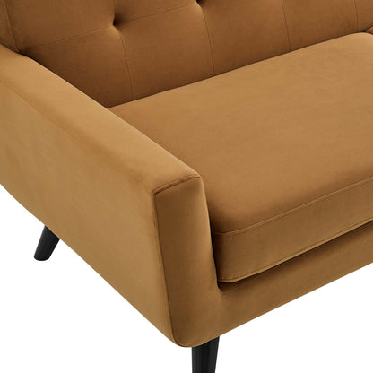 Cognac tan fabric armchair with tufted back, cushioned seat, and black angled legs.
