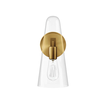 Brass wall sconce with clear glass cone shade and exposed Edison bulb.