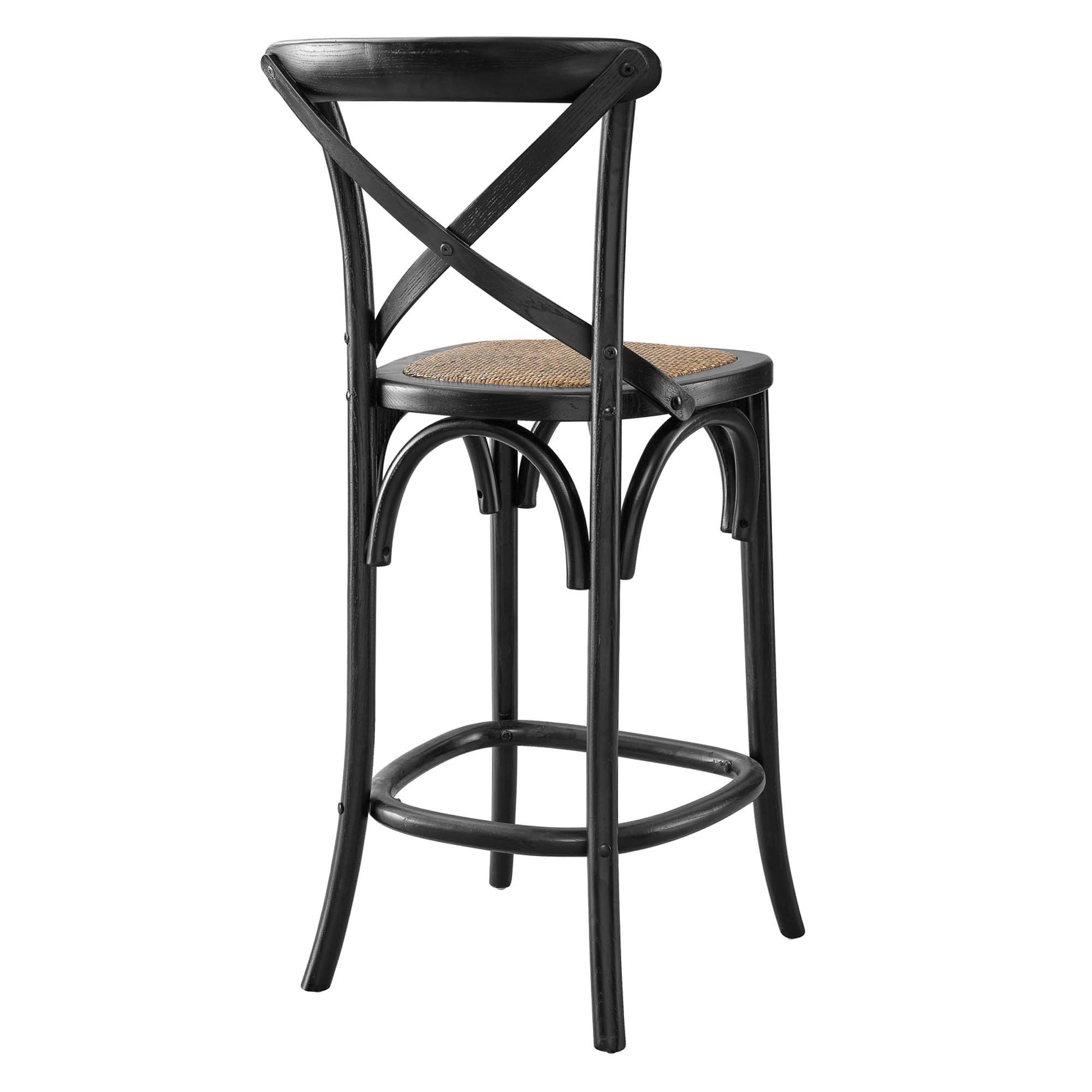 Black wood bar stool with woven cane seat, X-back, curved legs and circular footrest for bistro-style seating.