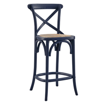 Navy blue counter stool with woven rattan seat, X-back, curved legs and circular footrest ring.