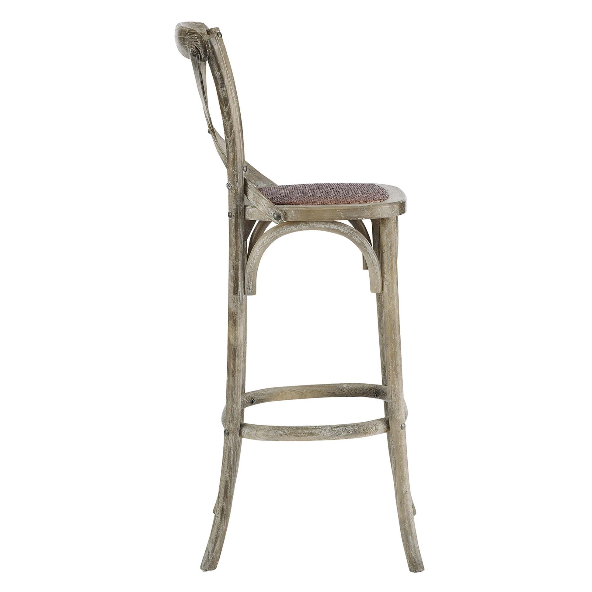 Weathered gray bar stool with woven cane seat, curved back, arched side supports, and circular footrest.