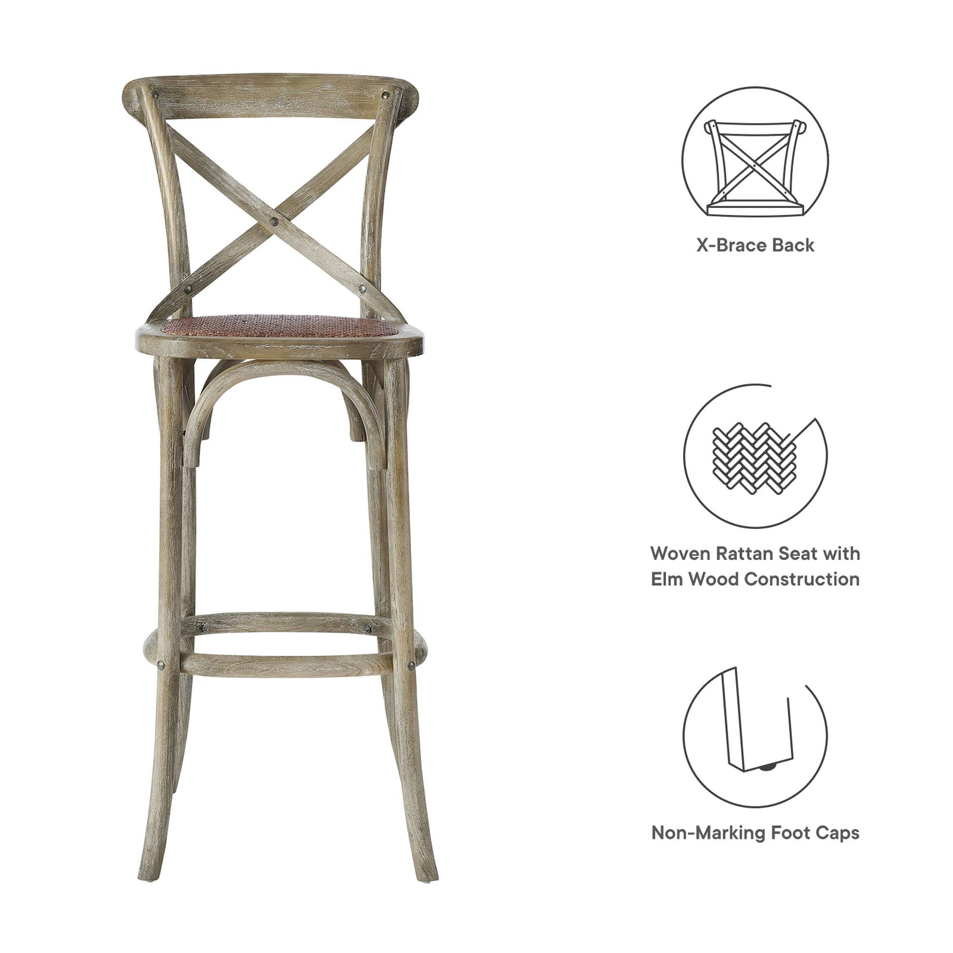 Weathered gray wooden bar stool with X-back, woven rattan seat, elm wood construction and non-marking foot caps.