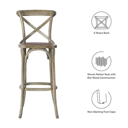 Weathered gray wooden bar stool with X-back, woven rattan seat, elm wood construction and non-marking foot caps.