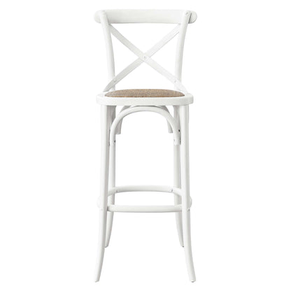 White bar stool with X-back, woven natural seat, curved legs and footrest ring.