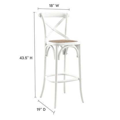 White metal bar stool with a woven natural cane seat, X-back, curved legs and circular footrest for kitchen counter use.