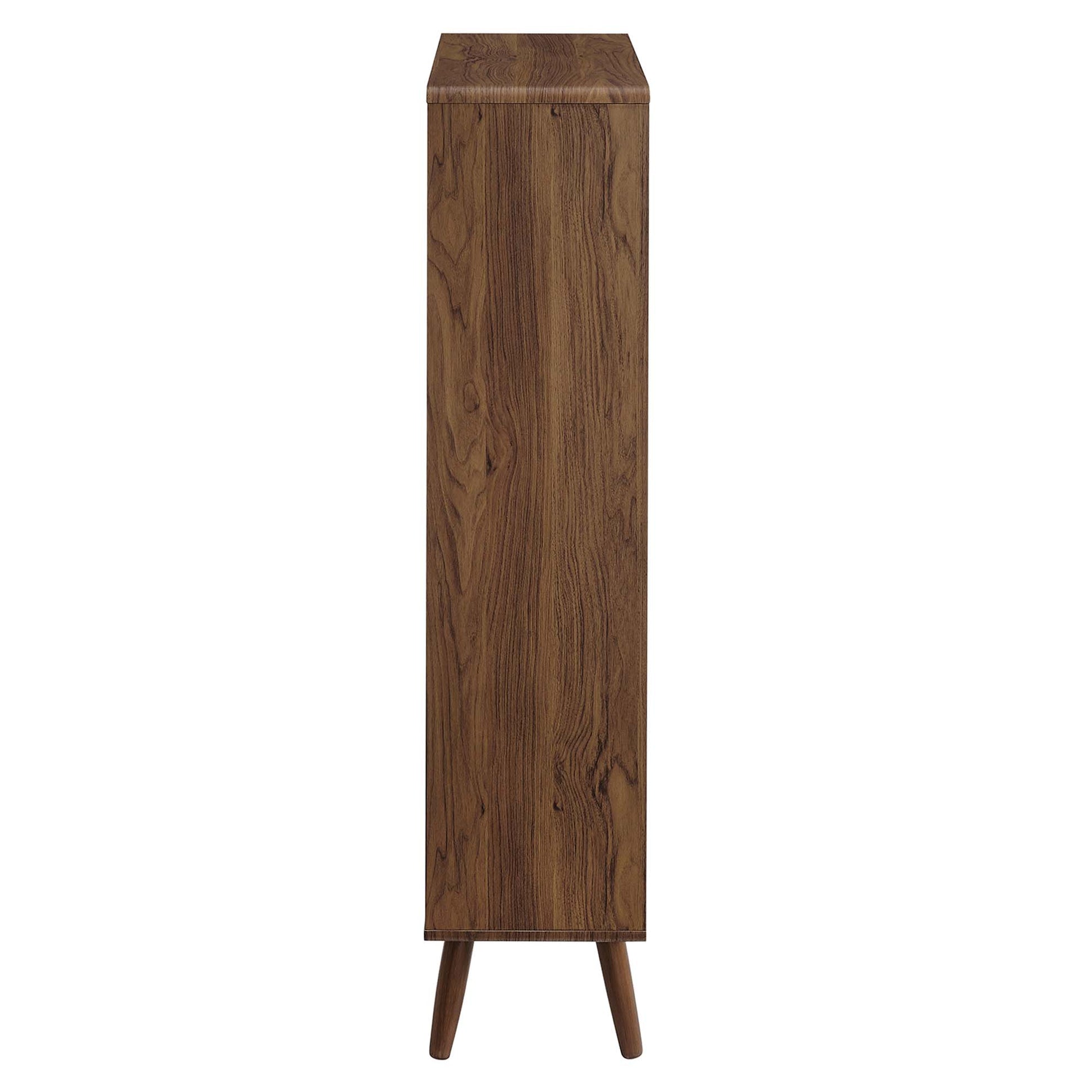 Tall walnut wood grain bookcase with five open shelves on three angled legs in a mid-century modern style.