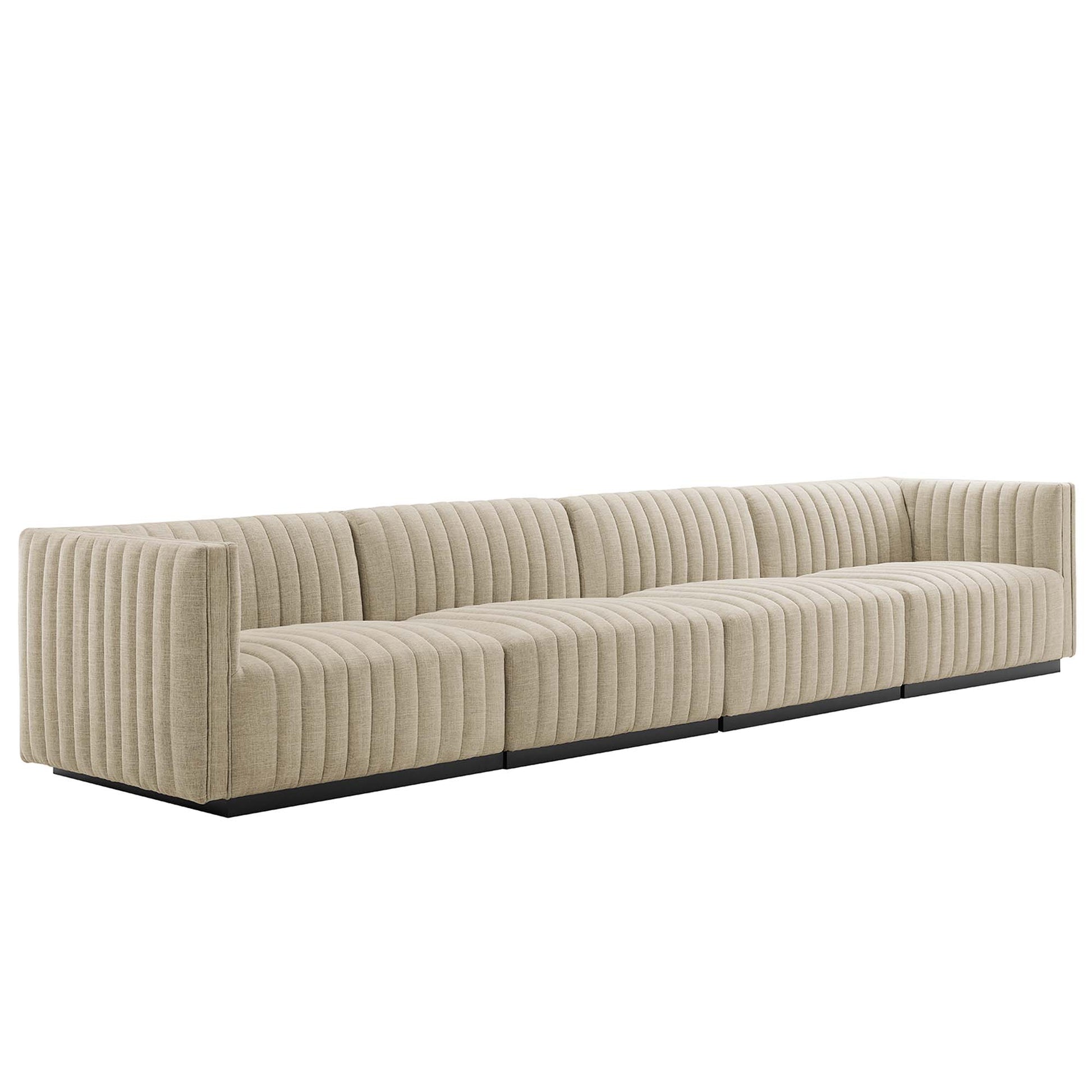 Beige corduroy channel-tufted modular sectional sofa on a low black platform base.
