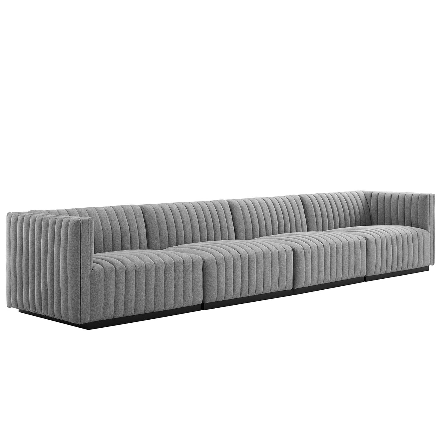 Long gray fabric sectional with vertical channel tufting, low black base, modern living-room sofa.