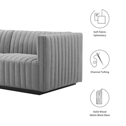 Gray soft-fabric upholstery with vertical channel tufting; square-arm sofa on a matte black solid-wood base.