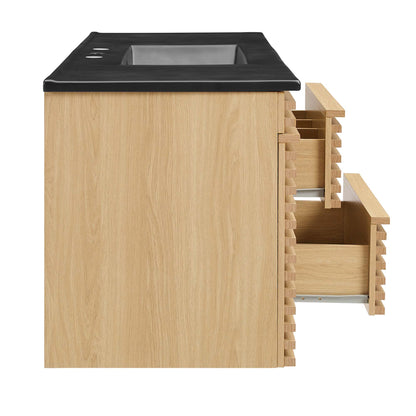 Oak wood vanity with black top, recessed bin area, and two side pull-out drawers.
