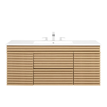 Oak slatted wood wall-mounted bathroom vanity with white countertop and chrome faucet.