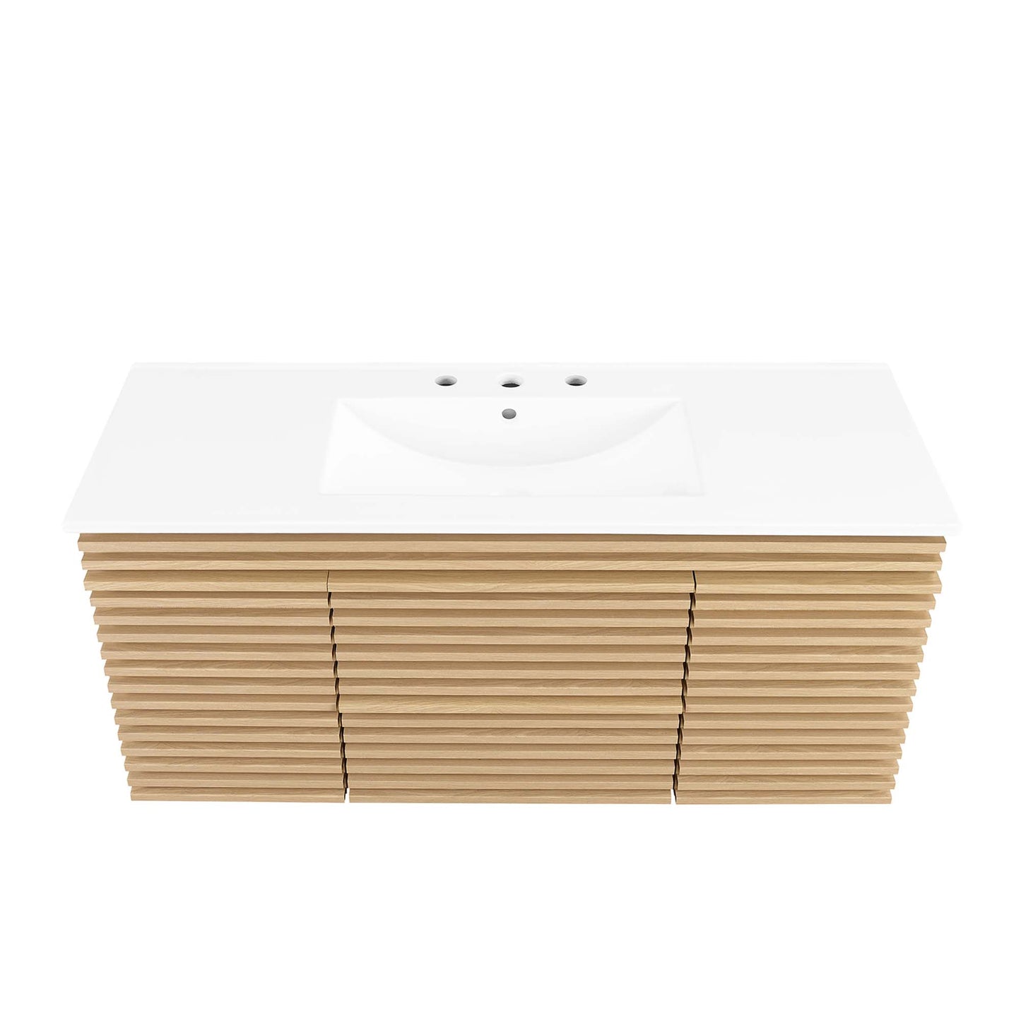 White countertop with integrated sink and three-hole faucet cutouts atop a light oak slat-front vanity cabinet.