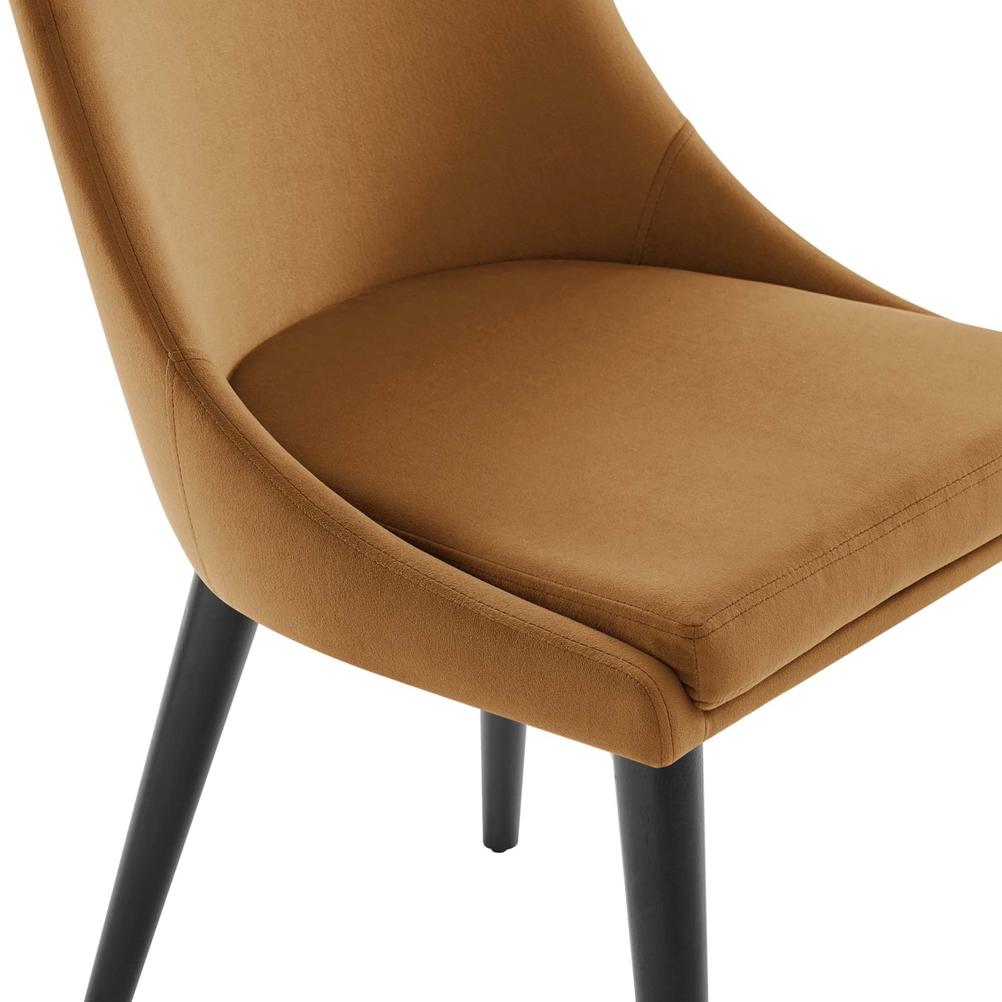 Pair of camel-brown upholstered dining chairs with curved backs, cushioned seats, and black tapered legs.