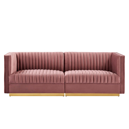 Dusty rose velvet sofa with vertical channel tufting, two-seat modular design, gold-tone wood base legs.