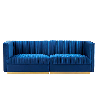 Navy velvet modular sectional sofa with vertical channel tufting and gold-tone legs.