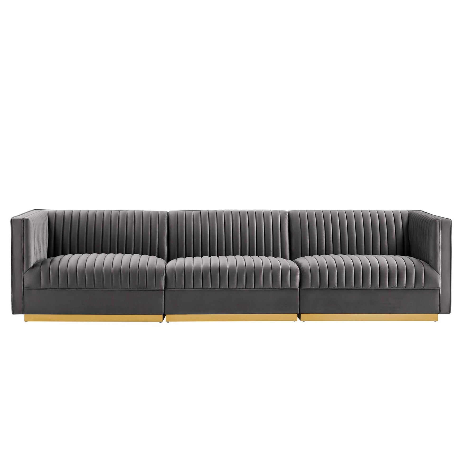 Grey fabric modular sofa with vertical channel tufting, three seats & light wood base.