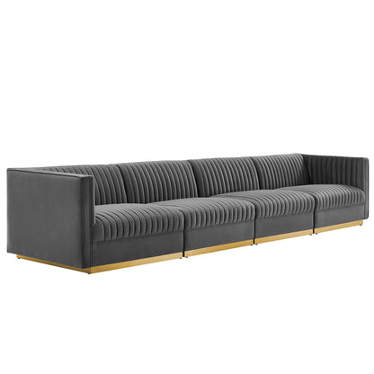 Gray modular sectional sofa with gold metal legs, vertical channel tufting, modern living room seating.