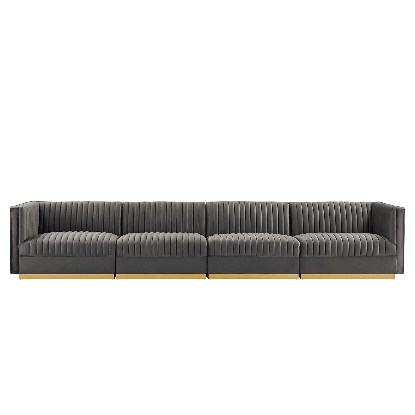 Long charcoal gray sectional sofa with vertical channel tufting, low arms, light wood legs.