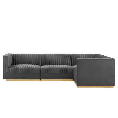 Dark gray velvet sectional with vertical channel tufting, right-facing L-shaped with chaise, light wood legs.