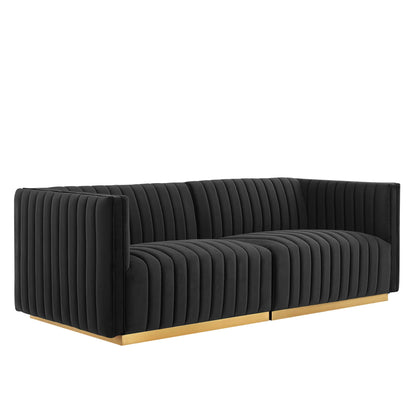 Black velvet loveseat with vertical channel tufting & a gold metal base, modern low-arm design.