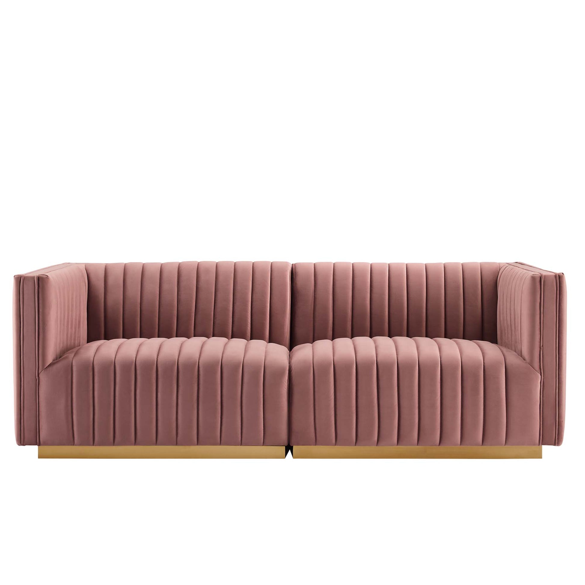 Dusty pink velvet loveseat with vertical channel tufting, two-seat sections, and a gold-tone base.