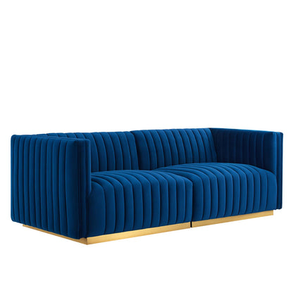 Navy velvet loveseat with vertical channel tufting and a gold metal base.