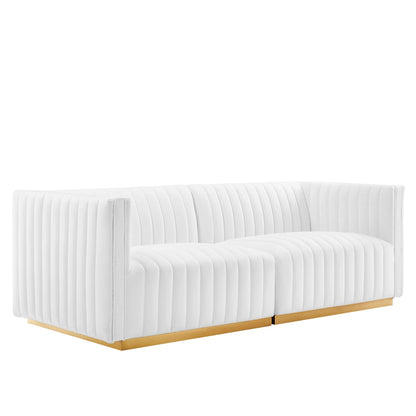 Low-profile white velvet channel-tufted loveseat with rectangular arms and gold metal base.