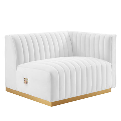 White tufted curved loveseat with vertical channel upholstery and gold base.