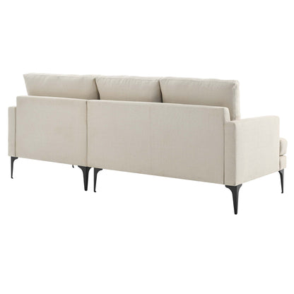 Beige upholstered fabric sectional sofa with slim black tapered legs and three back cushions, right-facing.