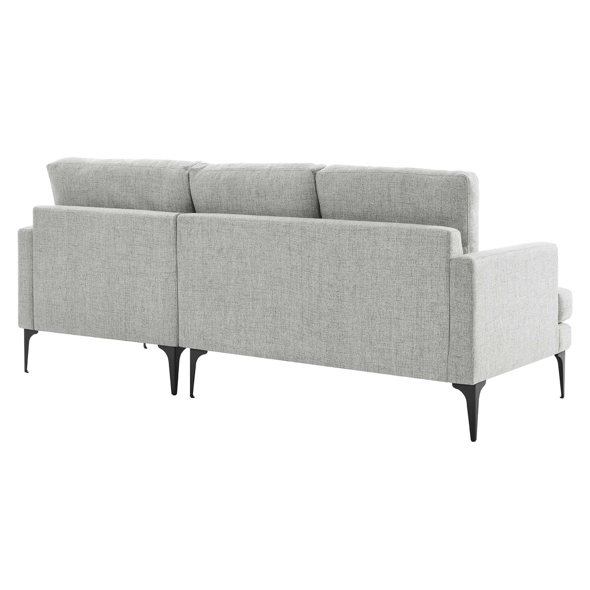Light gray textured fabric sectional with slim black tapered legs and three back cushions, contemporary living room seating.