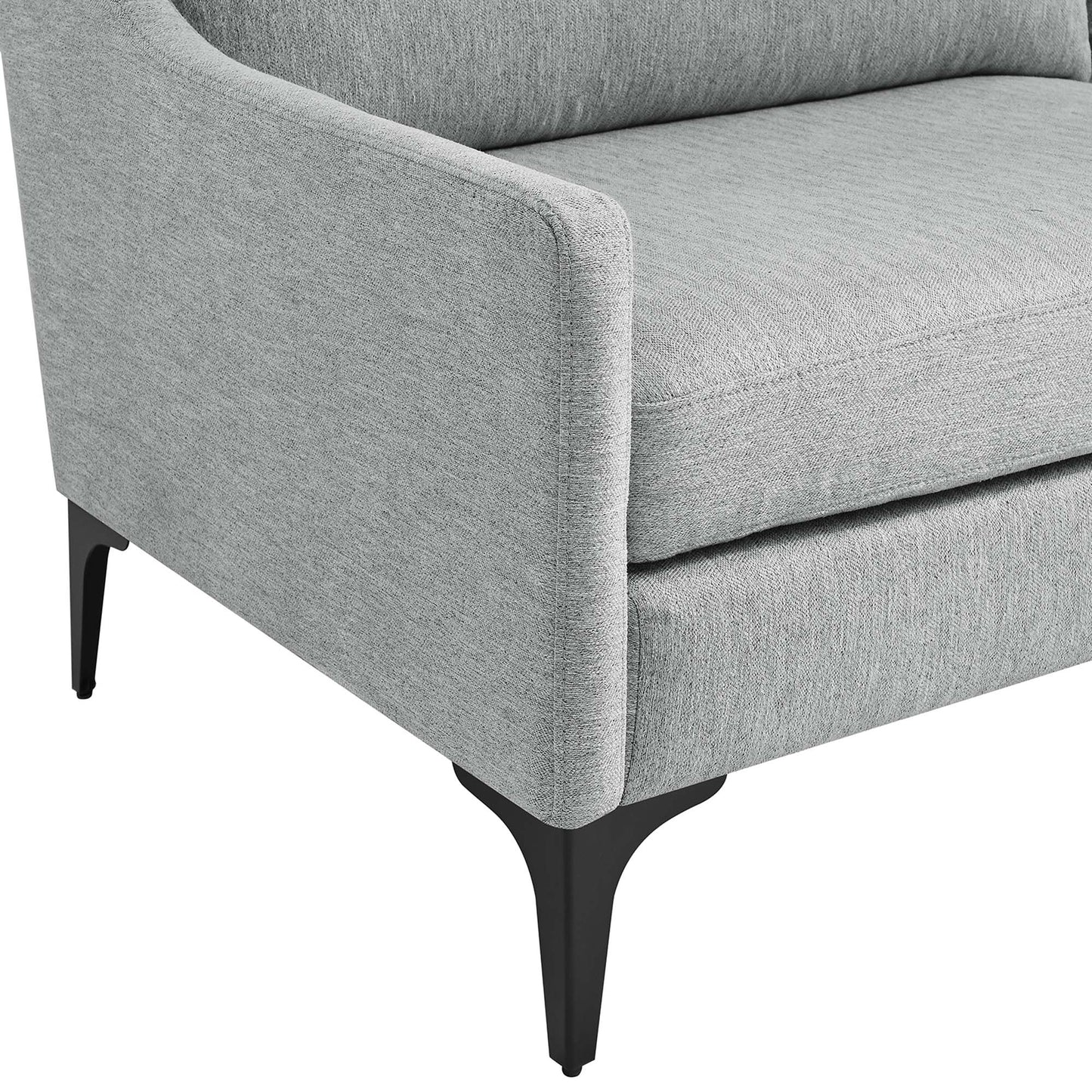Grey fabric upholstered sofa with curved arms, plush cushions, and black tapered legs.