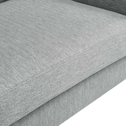 Close-up of seam edge on light gray textured fabric upholstery of a loveseat.
