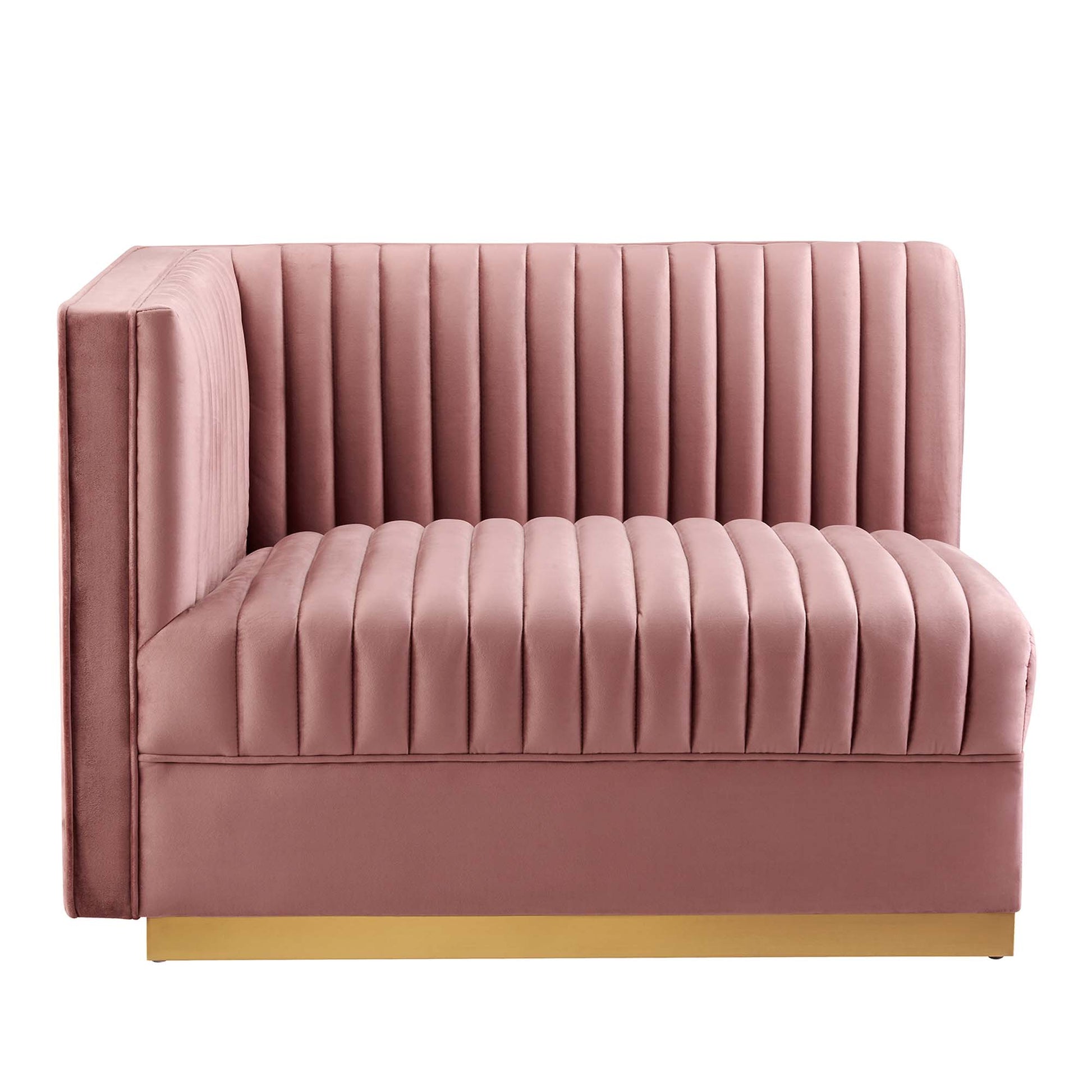 Red velvet modular sectional sofa with vertical channel tufting and a gold base.