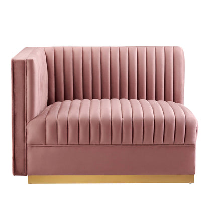 Red velvet modular sectional sofa with vertical channel tufting and a gold base.