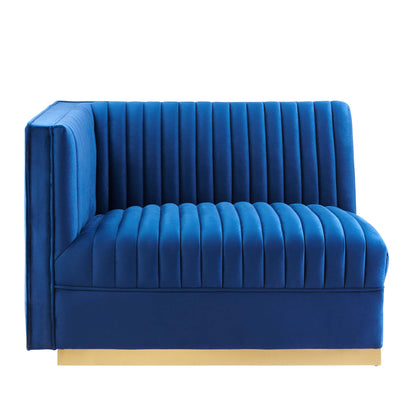 Navy blue velvet modular sectional sofa with left-arm chair, vertical channel tufting & slim gold plinth base.