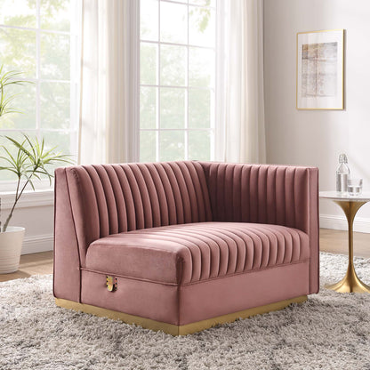 Red velvet channel-tufted modular sectional with right-arm chair and gold base in a bright living room.