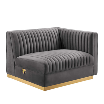 Grey velvet modular sectional sofa right-arm chair with deep vertical channel tufting and a gold-tone plinth base.