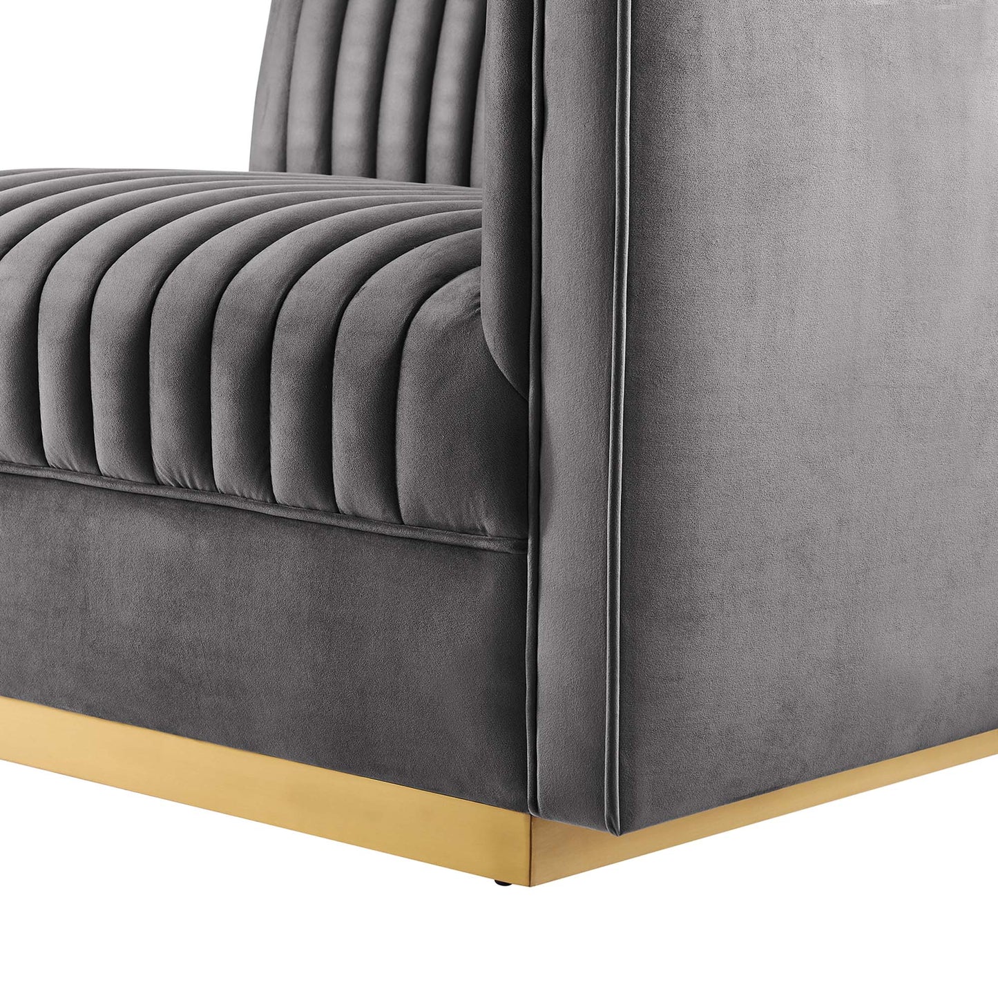 Gray velvet modular sectional sofa with right-arm chair, vertical channel tufting, square arms, and gold metal base trim.