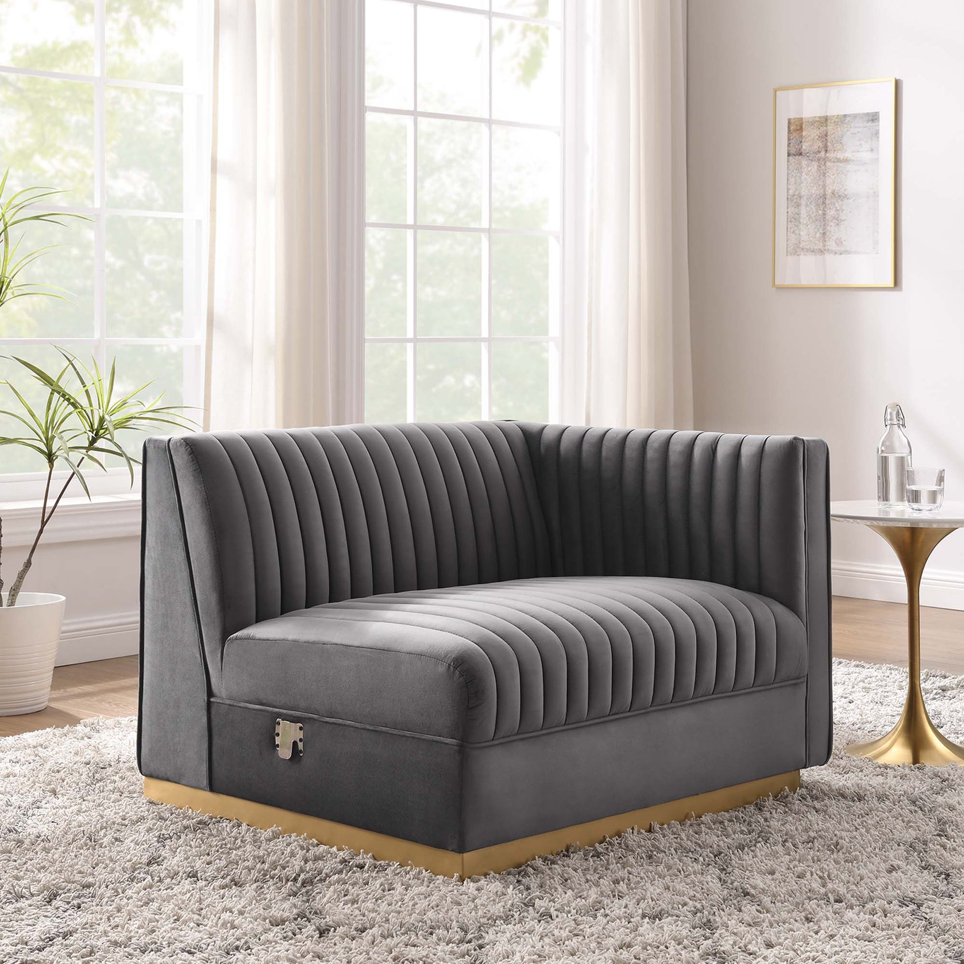 Gray velvet modular sectional sofa with channel-tufted cushions and a right-arm chair for contemporary living room seating.