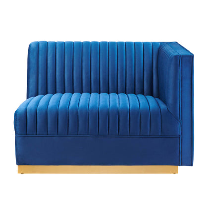 Navy blue velvet modular sectional sofa with channel tufting, square arms, and gold metal base.