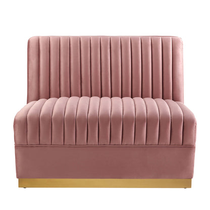 Red velvet channel-tufted armless chair, part of a modular sectional sofa, with a tall back and gold-tone base.