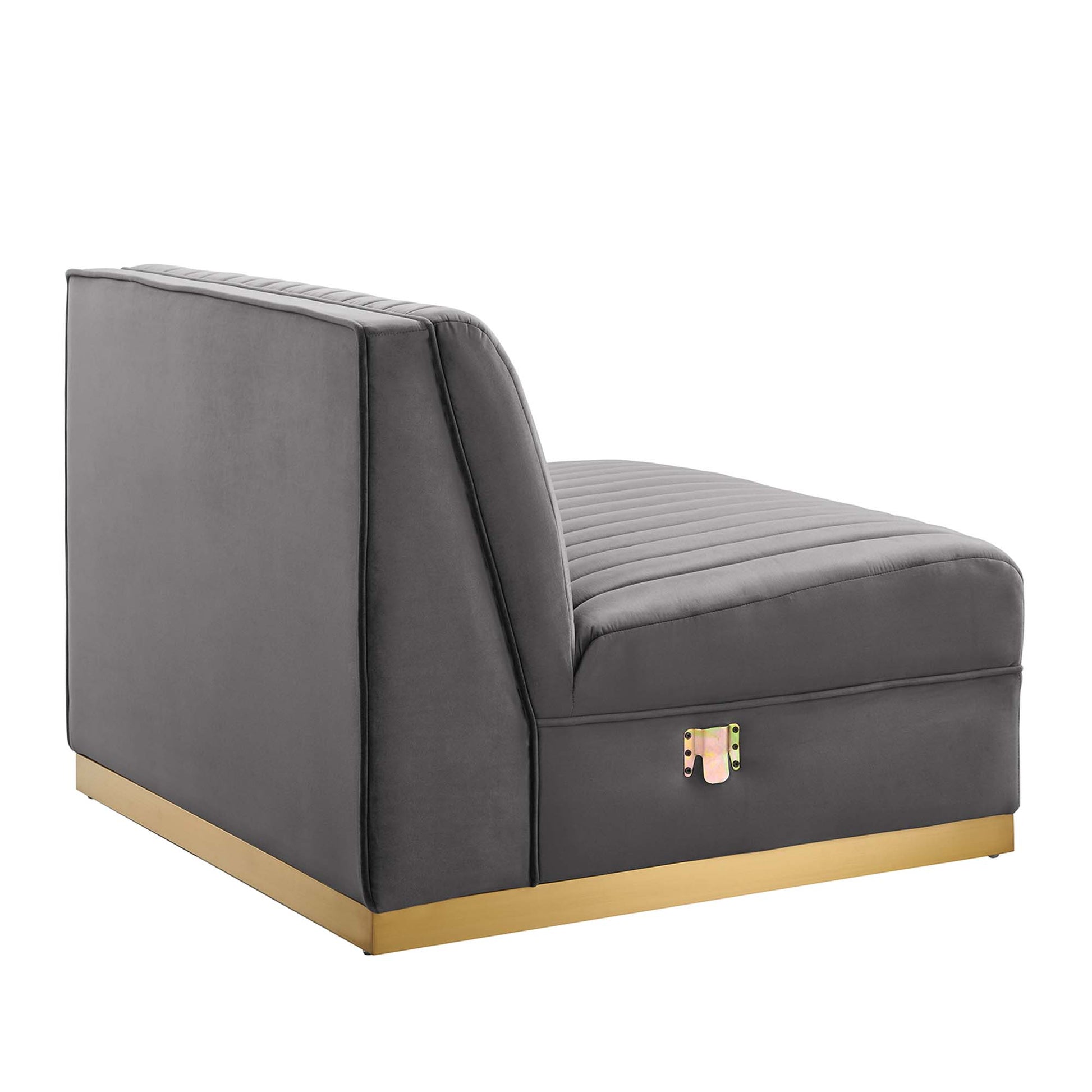 Gray velvet armless chair with channel-tufted seat, part of a modular sectional.